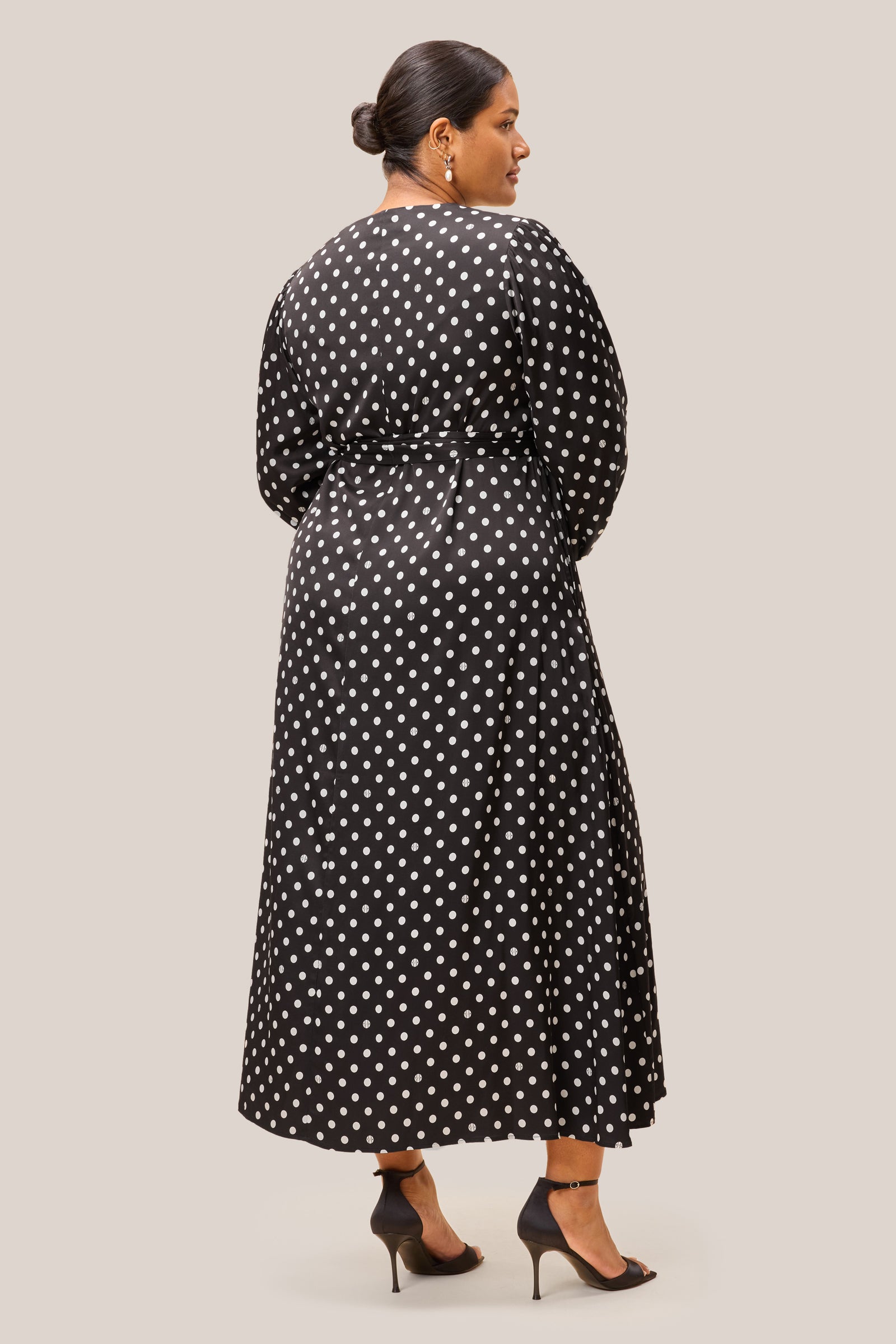 Back of black polka dot midi dress with removable belt and flattering flare. Plussize THE HOUR