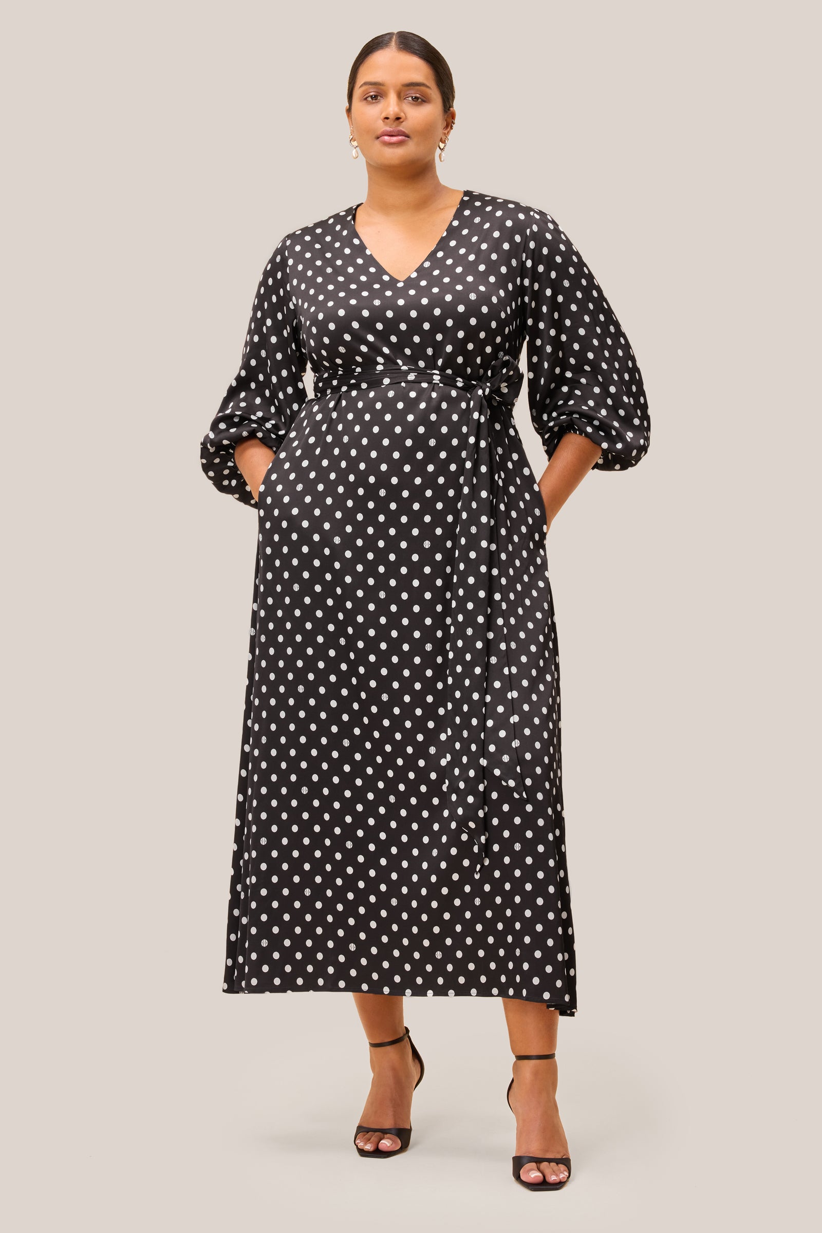 Black midi dress with white polka dots, V-neckline, belted waist THE HOUR PLUS SIZE