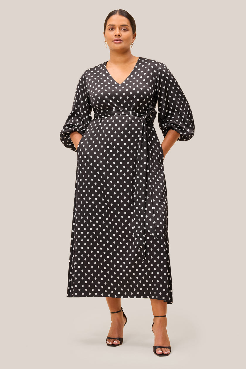 Black midi dress with white polka dots, V-neckline, belted waist THE HOUR PLUS SIZE