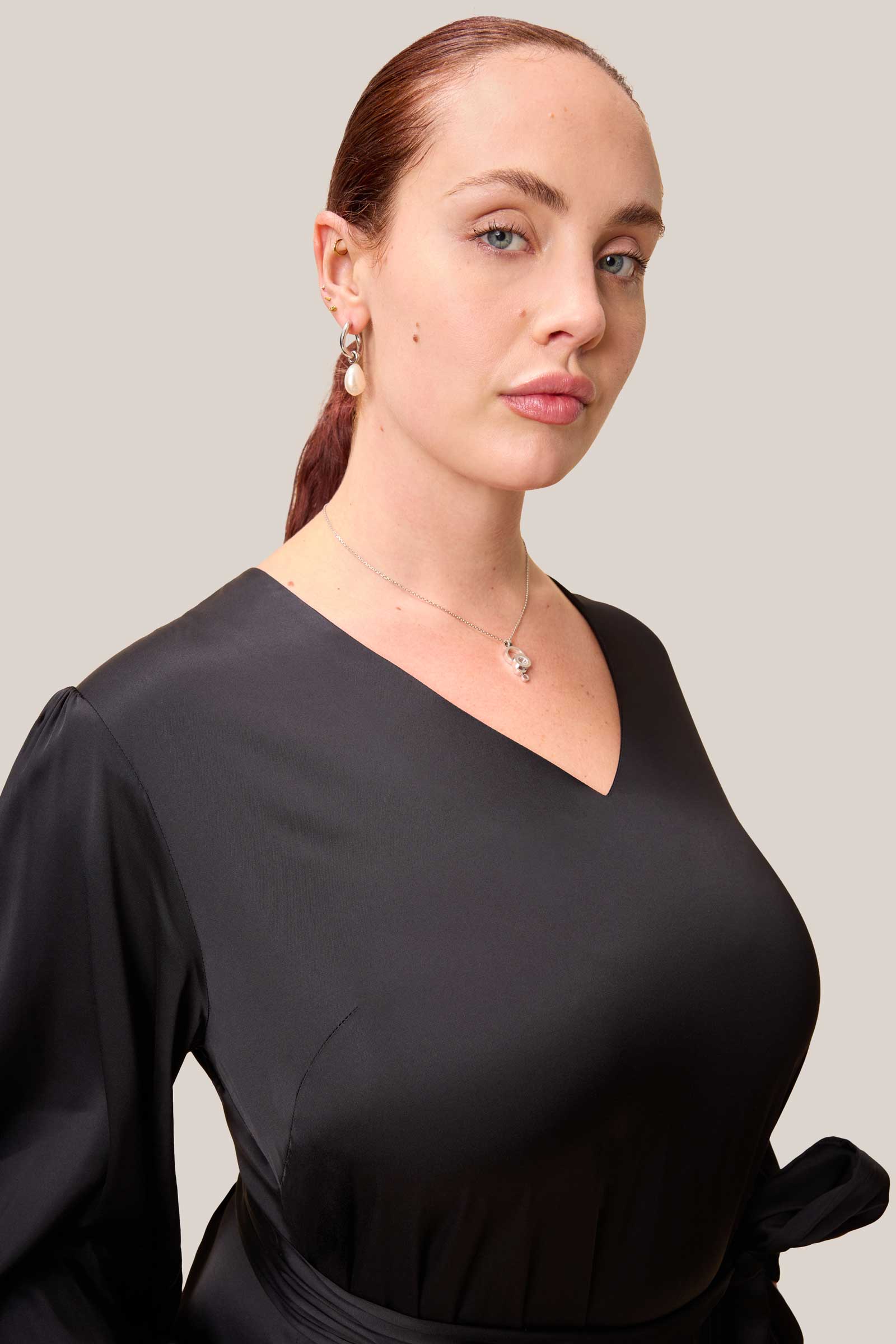 Smooth Italian satin-viscose fabric in solid black with soft, elegant sheen.