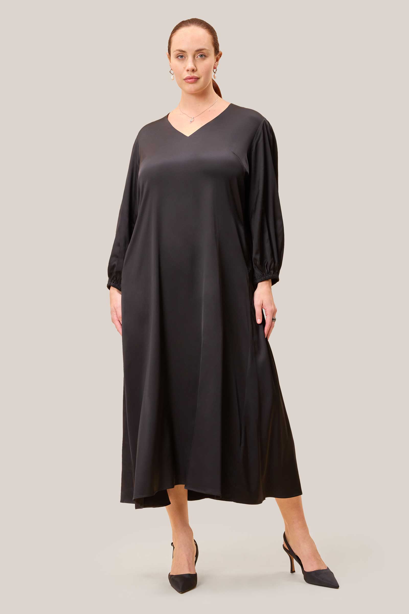 Black plus-size A-line midi dress with removable belt and fluid movement.