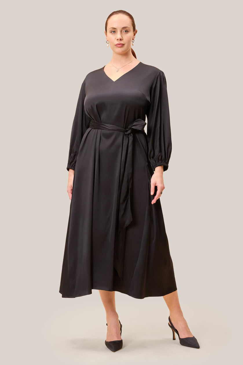 Black satin midi dress with V-neckline, belted waist and flattering A-line silhouette. PLUS-SIZE