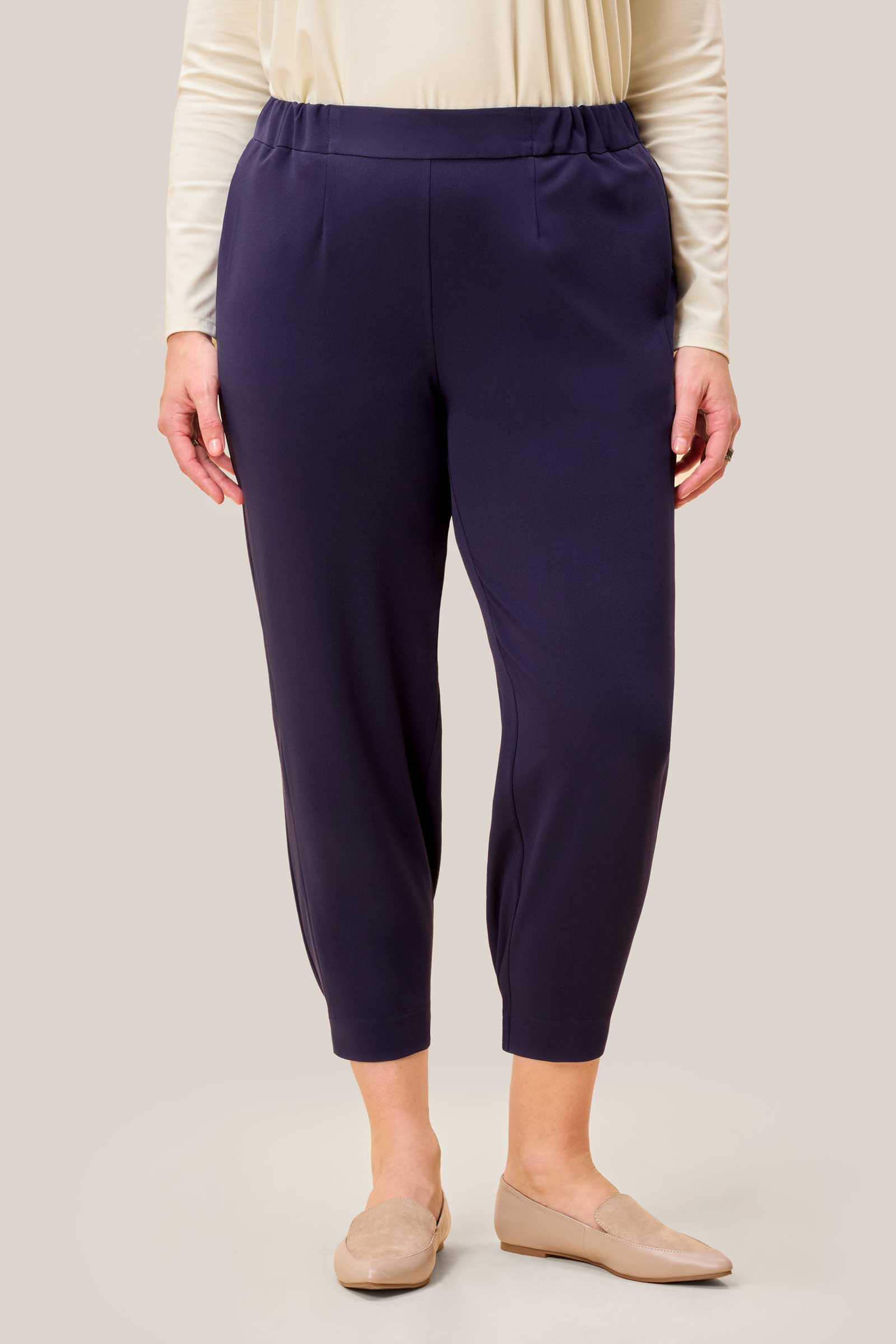 Full-length outfit shot featuring Smart Navy Joggers and neutral flats. THE HOUR