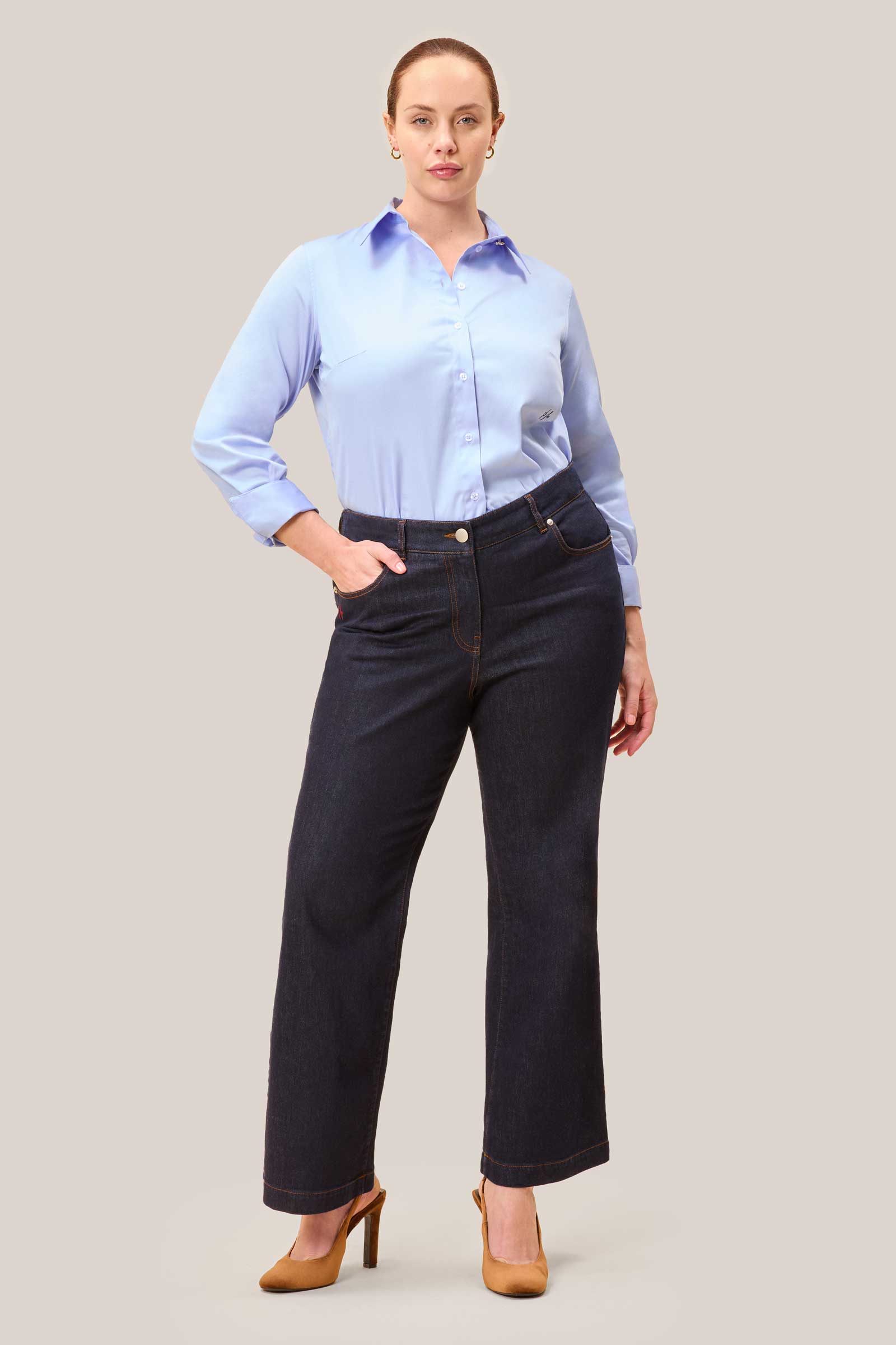 Plus size model wearing blue cotton sateen shirt with gold collar button – front view, The Hour