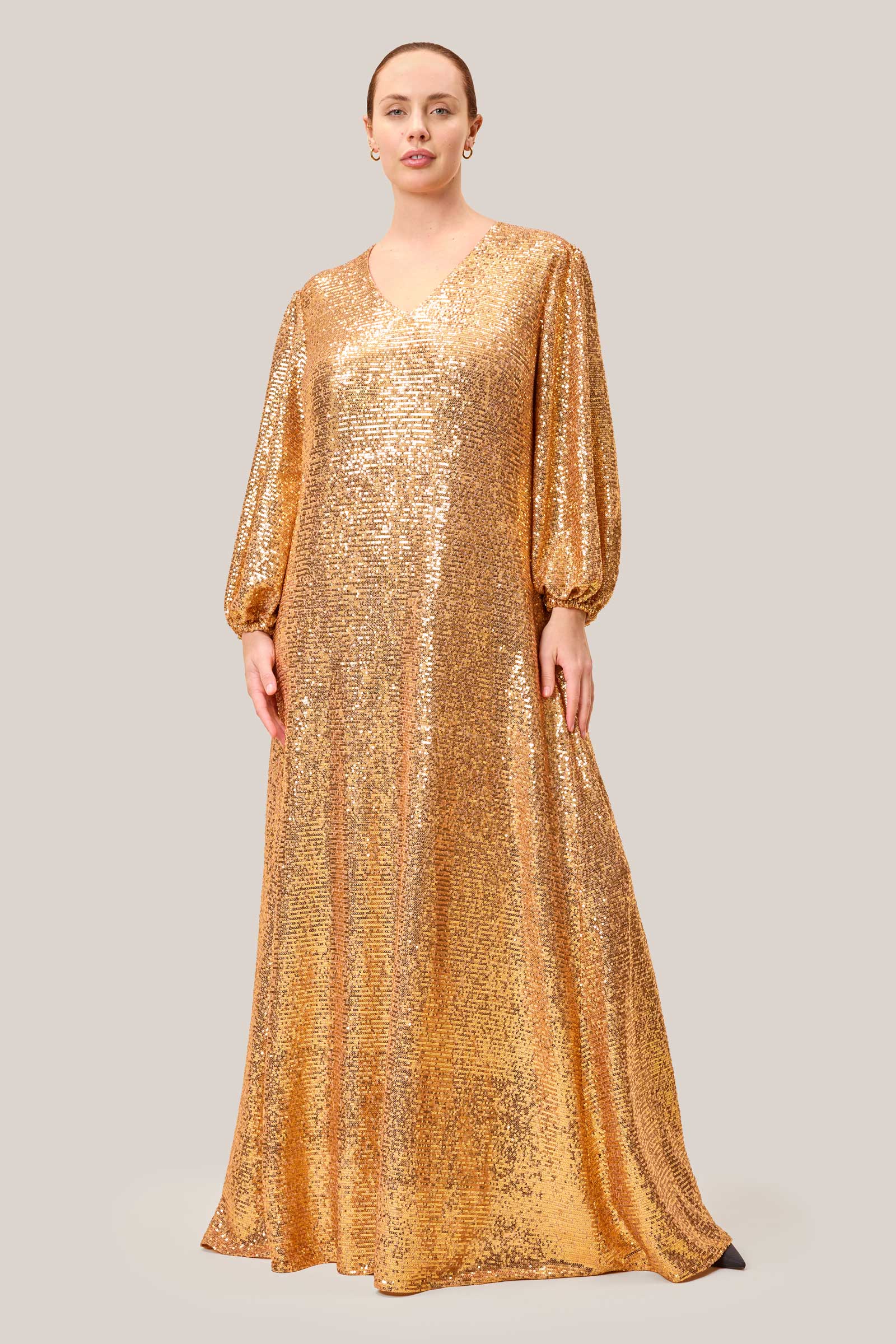 shimmering gold sequin maxi dress, featuring a flattering V-neck and gathered sleeves.