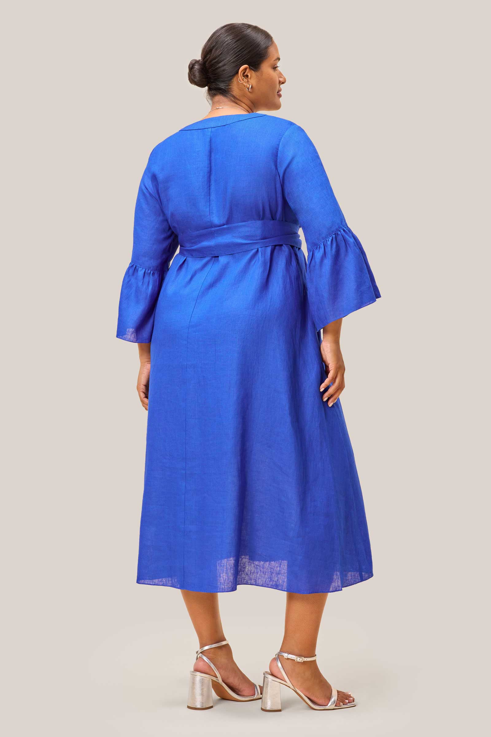 Back of royal blue linen dress showing relaxed A-line fit and bell sleeves