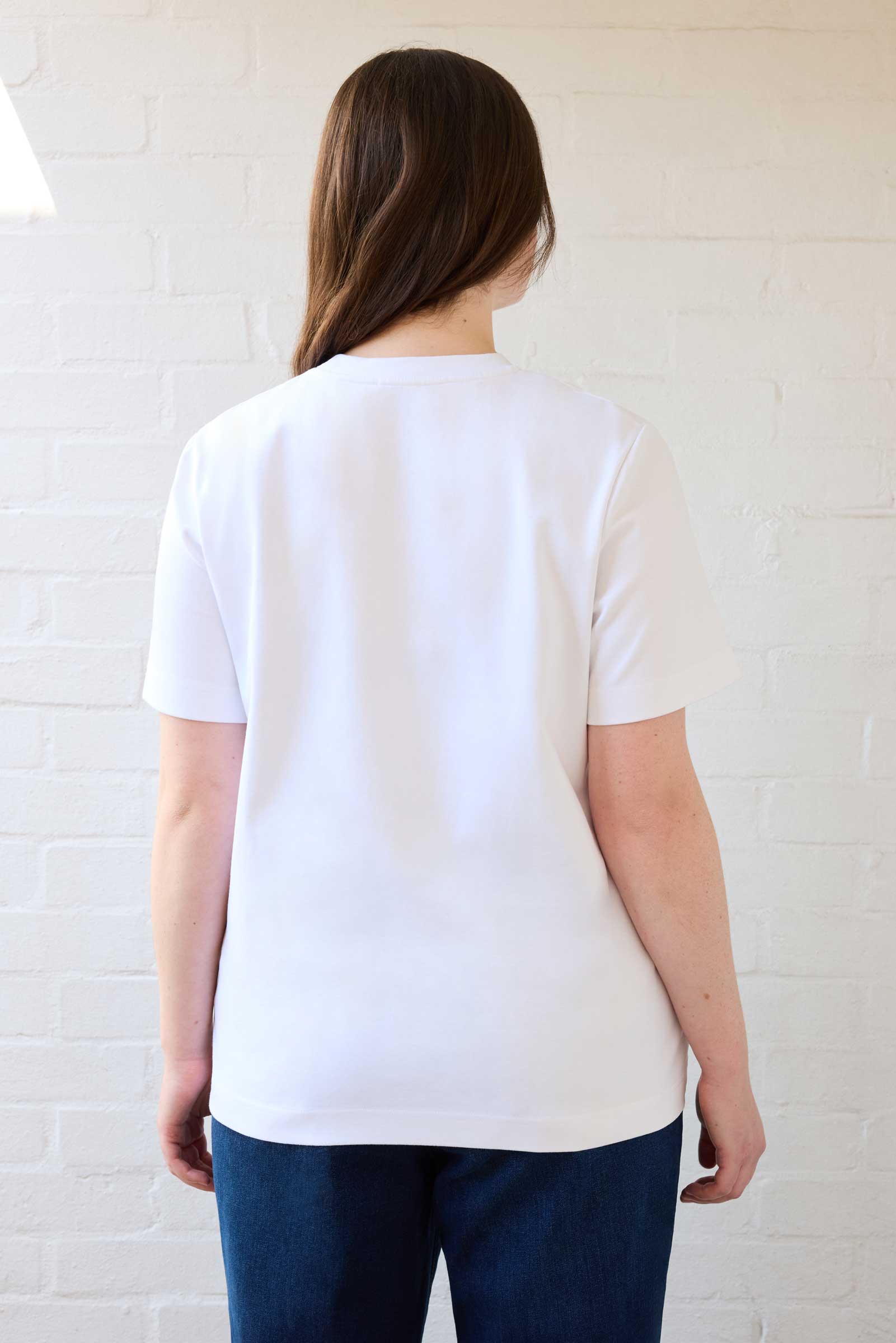 Back view of plus size organic cotton T-shirt in white, designed for curvy women by The Hour