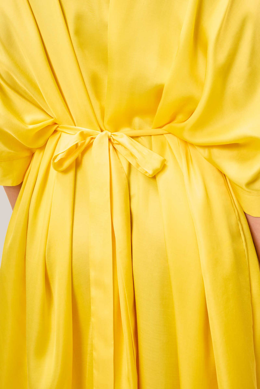 Close-up of back tie detail on yellow satin kaftan