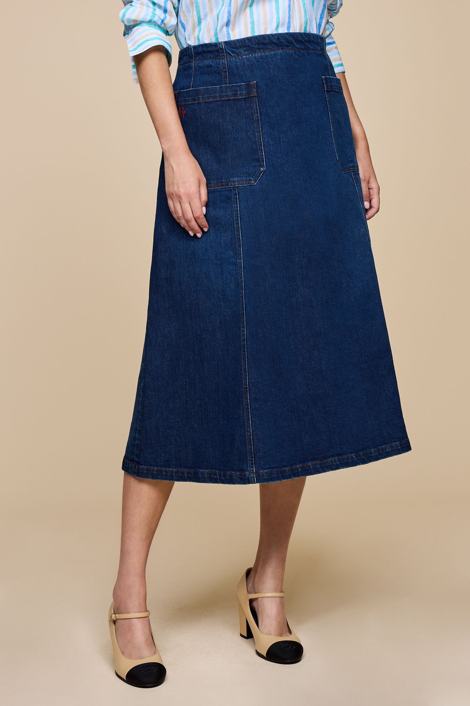 Full-length side view of The Hour denim skirt