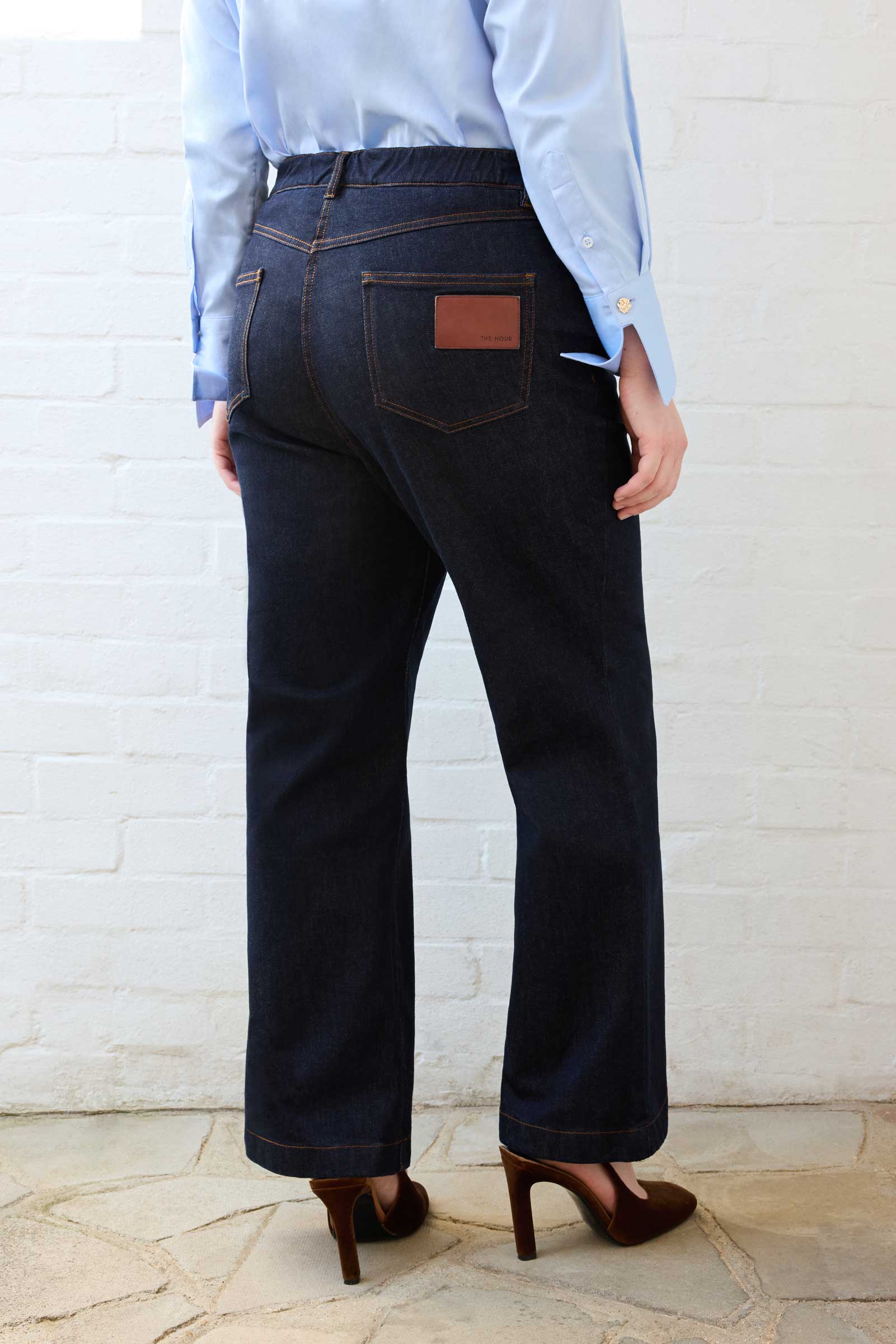 Back view of The Hour London’s dark indigo high waisted wide leg jeans
