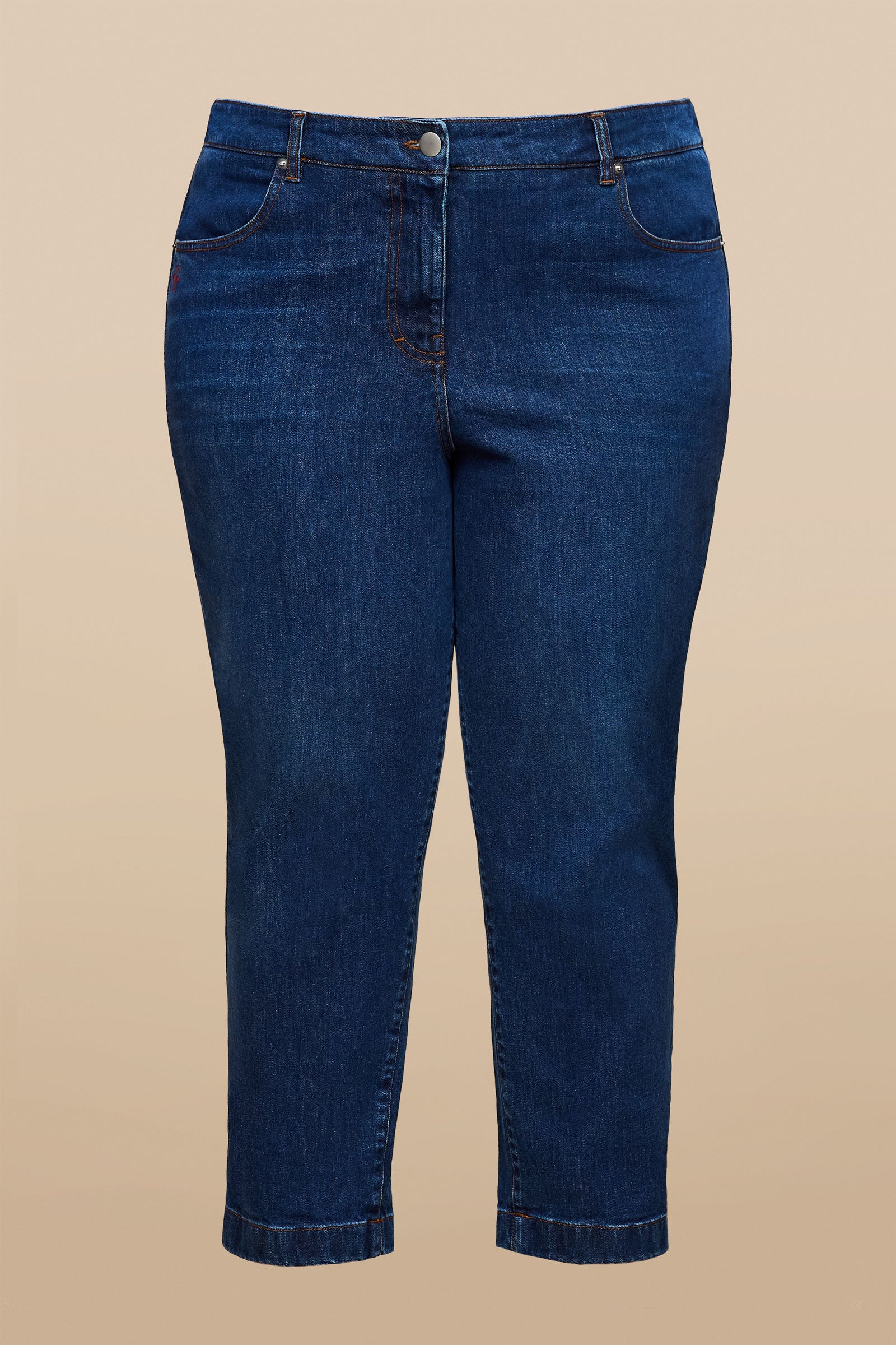 Flat lay of plus size tapered jeans in mid-blue stretch denim