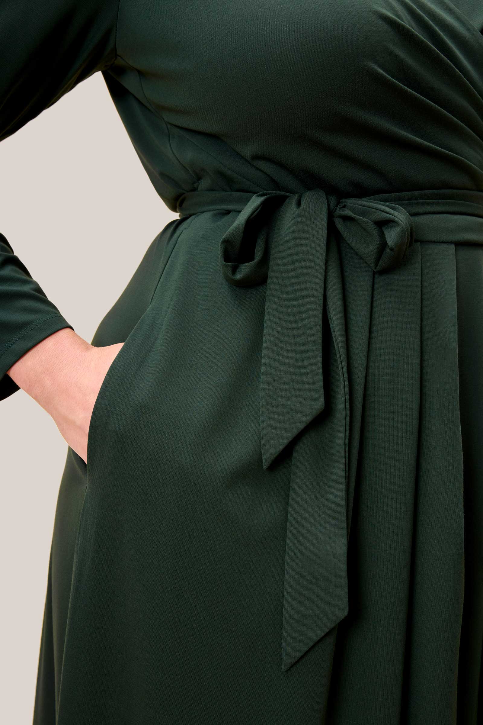 Side pocket detail of plus size faux wrap jersey midi dress in olive green – The Hour