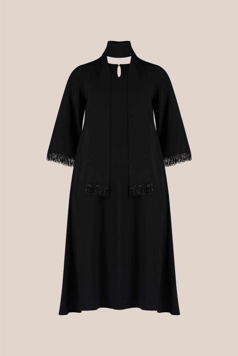 A-line black plus size maxi dress. It has wide sleeves decorated with a beaded fringe