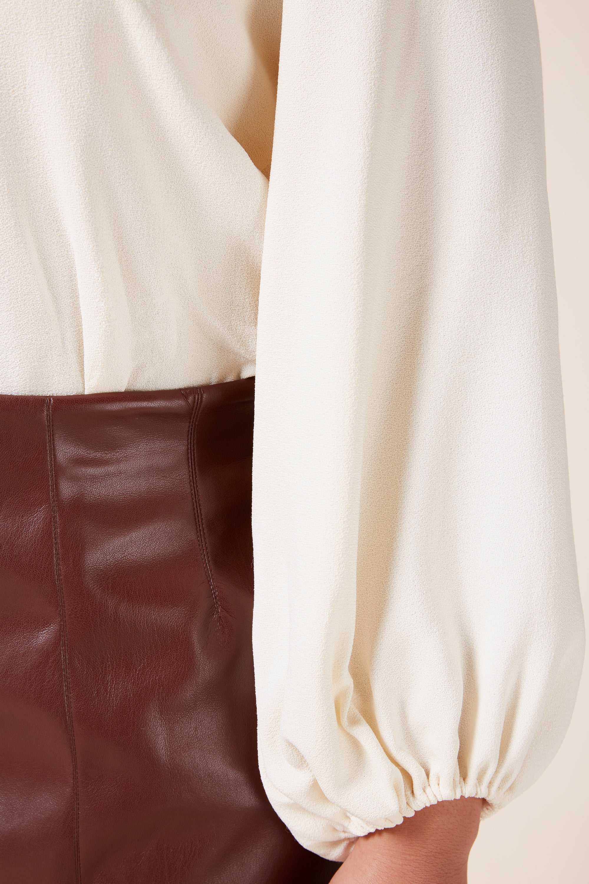 CRÈME CADY PLUS SIZE TOP WITH BLOUSON SLEEVES AND THE HOUR LEATHER SKIRT