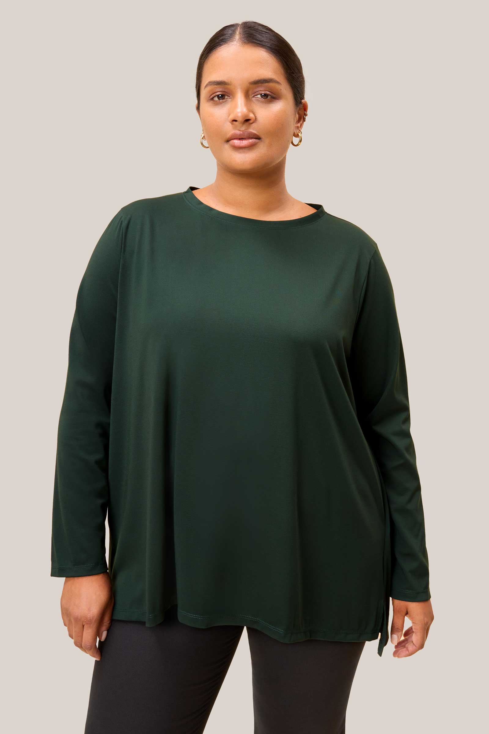 olive green jersey top styled with wide-leg trousers. THE HOUR