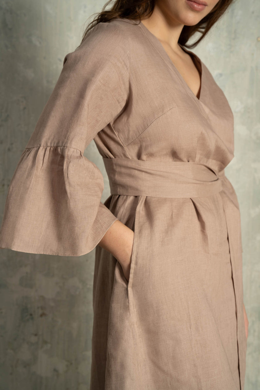 Brown linen dress with bell sleeves on a plus-size woman