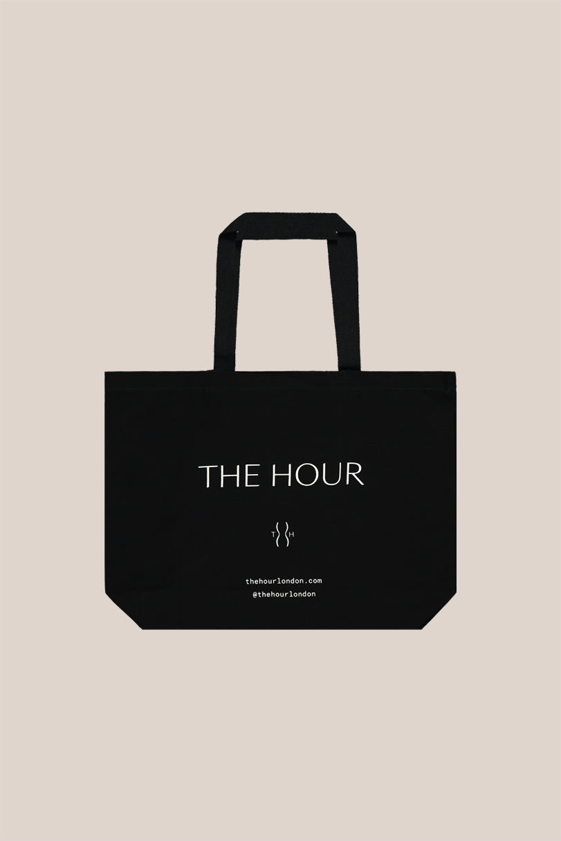 THE HOUR black cotton tote bag designed to last a lifetime. Black with THE HOUR  logo in white